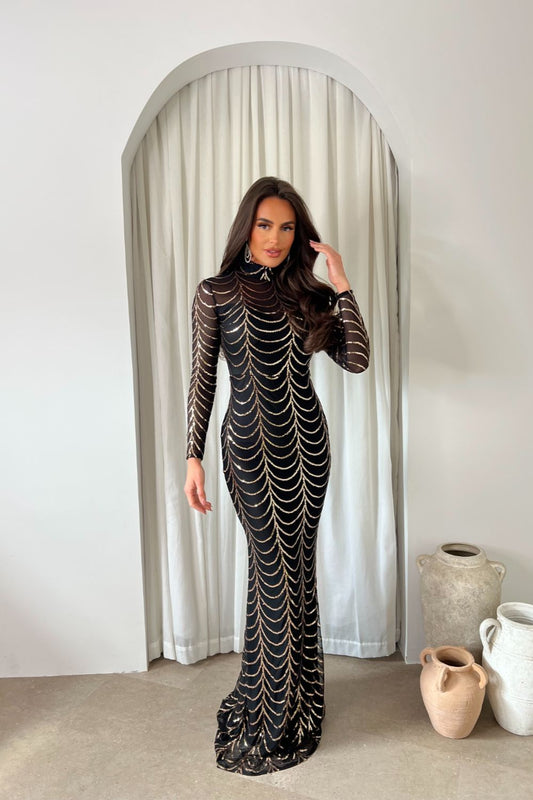 Maxivestido Nyla Black Rose Gold Luxe VIP: corte sirena, manga larga, efecto ilusión y adornos de lentejuelas.